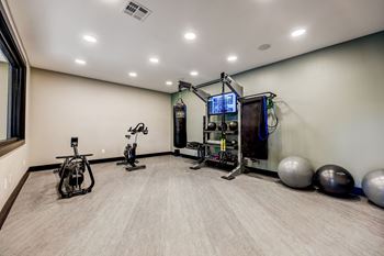 A well-equipped home gym with a variety of exercise equipment. at Ventana Oaks Apartments, Texas
